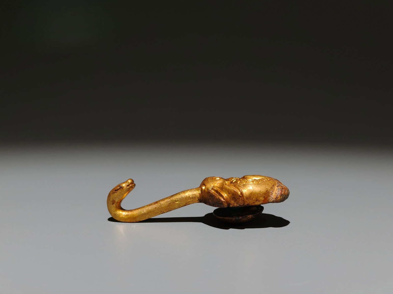A Exquisite Gilt Bronze Rabbit Shaped Handheld Carving: A Exquisite Gilt Bronze Rabbit Shaped Handheld Carving,Han Dynasty, China,Size:3.1inx1.2in,Weight:g 铜鎏金兔形手把件,中国汉代