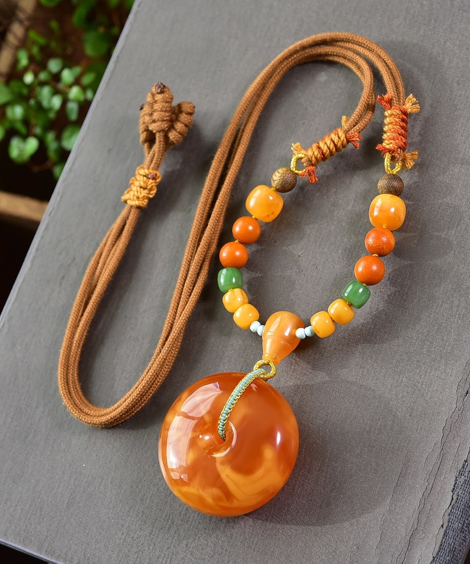 A Exquisite Amber Lucky Circle Pendant Necklace: Amber Lucky Circle Pendant Necklace,Qing Dynasty, China,Size:1.5inx0.7in, Weight:27g 蜜蜡平安扣吊坠项链,中国清代