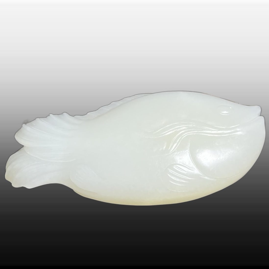 A Exquisite Hotan White Jade Fish Handheld Carving: A Exquisite Hotan White Jade Fish Handheld Carving,Qing Dynasty, China,Size:3.9inx0.7inx2in,Weight:146g 和田白玉鱼手把件,中国清代