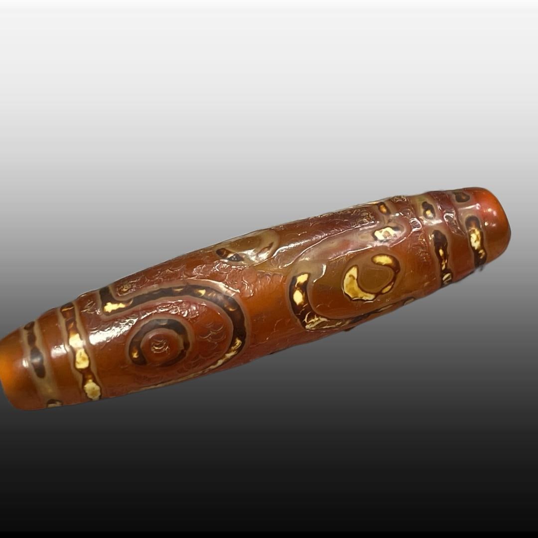A Exquisite Ruby Six Eyes Dzi bead: A Exquisite Ruby Six Eyes Dzi bead,Tang Dynasty, China,Size:0.5inx2.2in 红玉六眼天珠,中国唐代