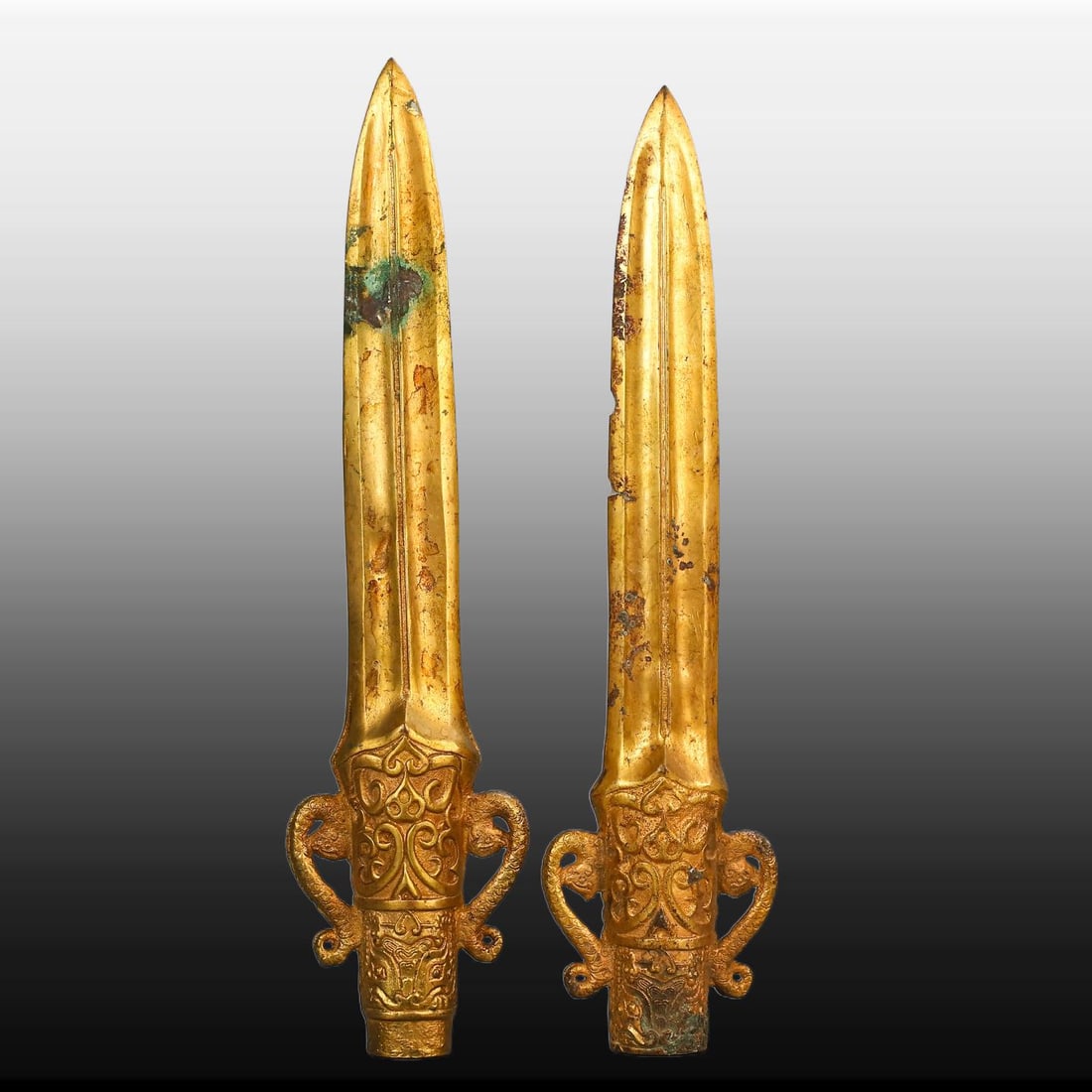 A pair of Exquisite Gilt Bronze Weapon: A pair of Exquisite Gilt Bronze Weapon,Han Dynasty, China,Size:11.8inx2.8in(Weapon),Weight:1060g 一对铜鎏金兵器,中国汉代