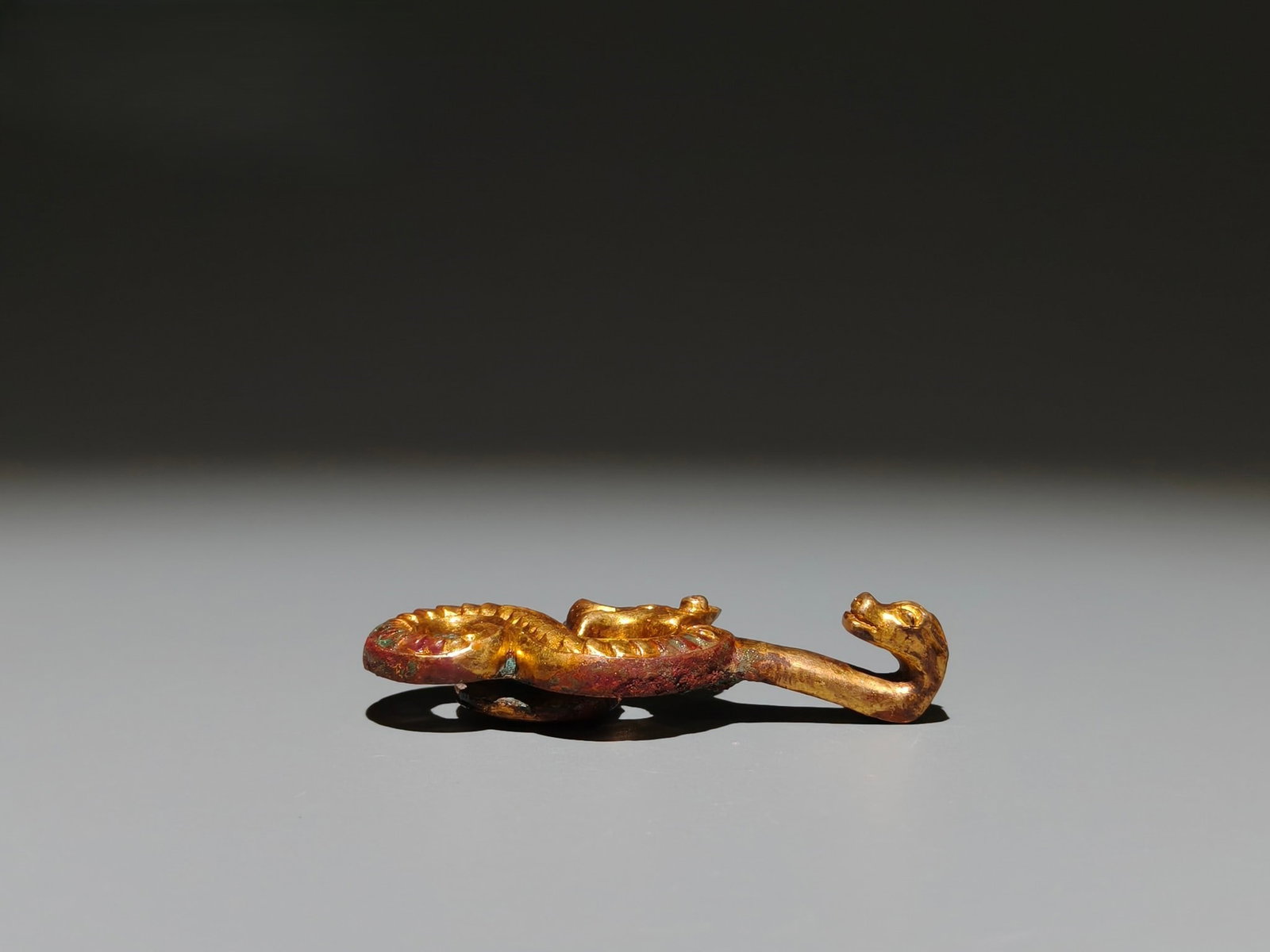 A Exquisite Gilt Bronze Dragon Handheld Carving: A Exquisite Gilt Bronze Dragon Handheld Carving,Han Dynasty, China,Size:2.9inx1.1in,Weight:g 铜鎏金龙手把件,中国汉代
