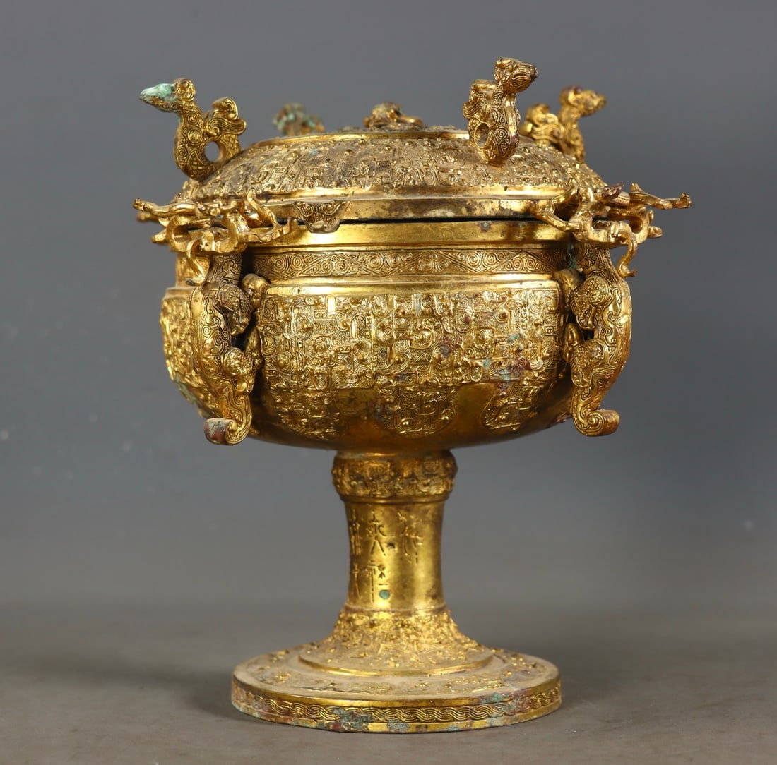 An Exquisite Gilt Bronze Beast-Face Pattern Censer: An Exquisite Gilt Bronze Beast-Face Pattern Censer Han Dynasty, China Size:7.9inx7.9in Weight:1435g铜鎏金兽面纹四兽尊