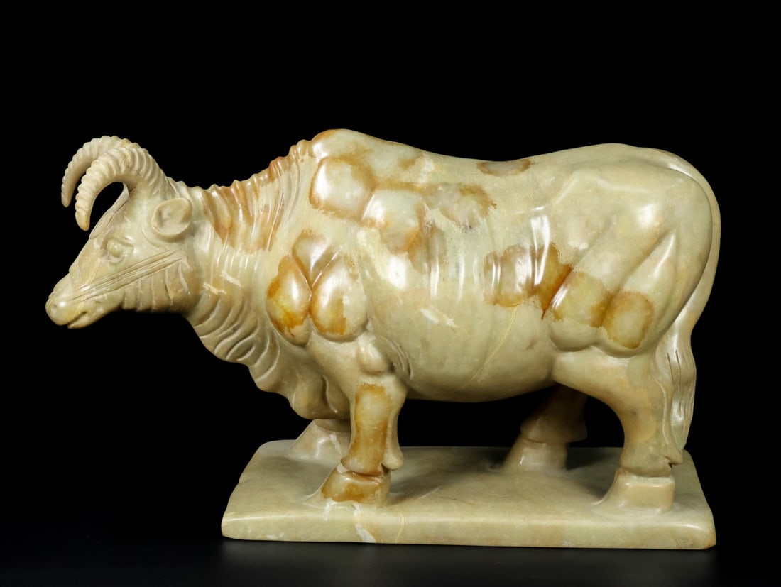 An Exquisite White Jade Buffalo Ornament: An Exquisite White Jade Buffalo Ornament Han Dynasty, China Size:11.9inx18.9inx7.5in Weight:27000g白玉牛摆件 中国汉代 Size:30.2cmx48cmx19cm