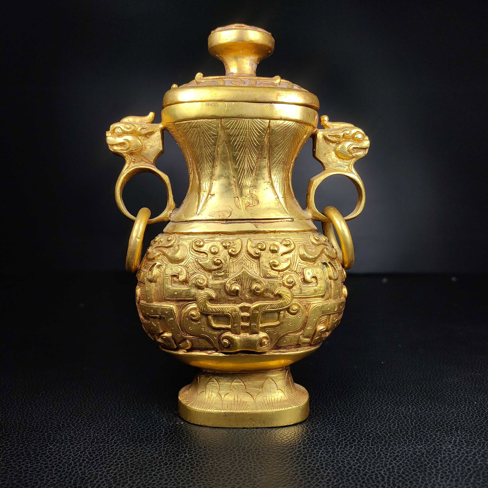 An Exquisite Gilt Bronze Beast-Face Pattern Double-Ears Vase: An Exquisite Gilt Bronze Beast-Face Pattern Double-Ears Vase N.Zhou , China Size:7.1inx4.3in Weight:1106g铜鎏金兽面纹双耳瓶 商周ਲ