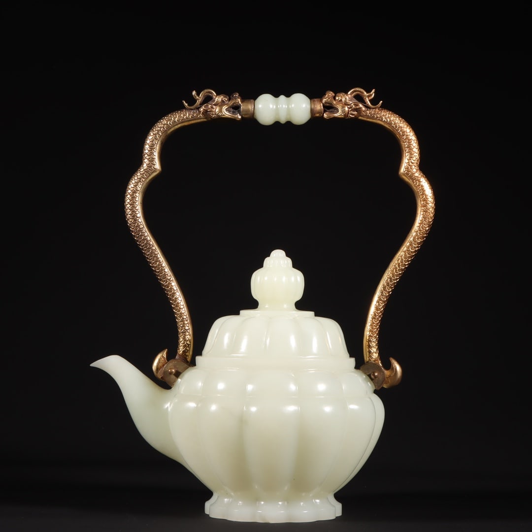 An Exquisite White Jade Inlaid Gilt Bronze Teapot: An Exquisite White Jade Inlaid Gilt Bronze Teapot Qing Dynasty, China Qianlong Four-character Mark Size:9.1inx6.7inx4.2in Weight:819g白玉提梁壶 中国清&#