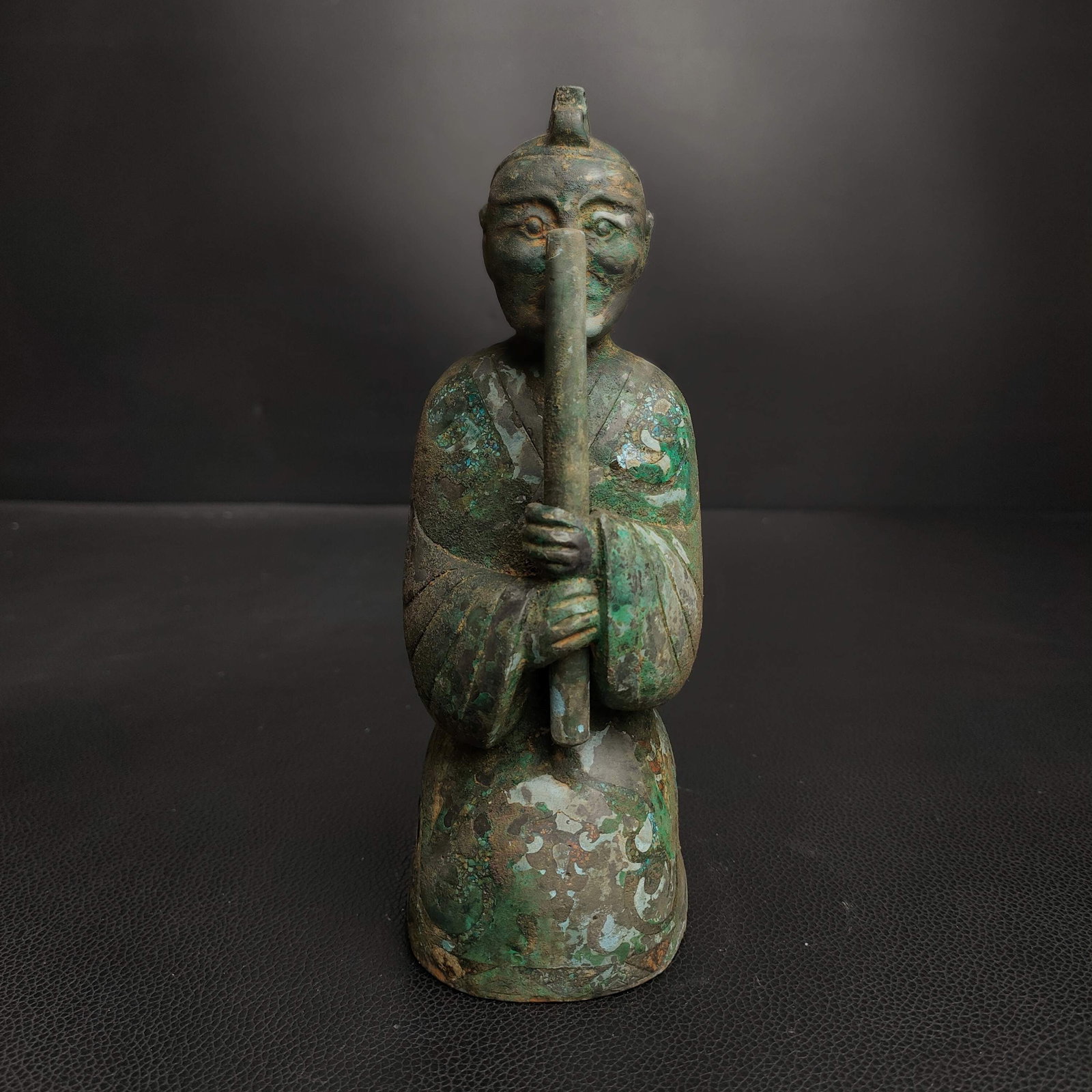 An Exquisite Bronze Figure Ornament: An Exquisite Bronze Figure Ornament Han Dynasty, China Size:3.1inx4.7in Weight:0.7kg青铜松石吹箫铜俑 中国汉代 Size:8cmx12cm