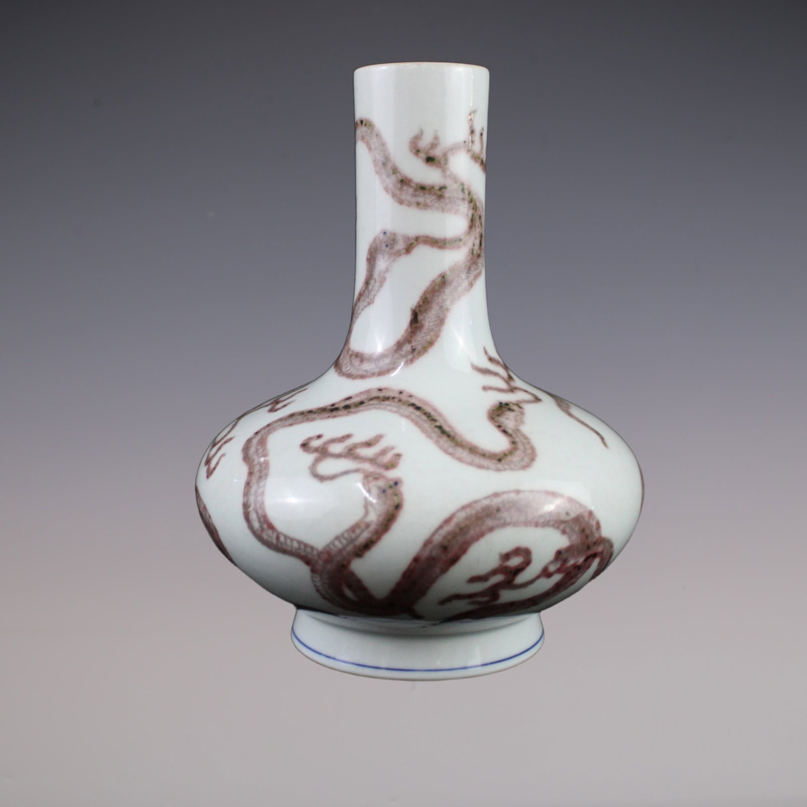 An Exquisite Underglaze-Red Dragon Pattern Vase: An Exquisite Underglaze-Red Dragon Pattern Vase Qing Dynasty, China Jiaqing Six-character Mark Size:22.cmx10.cm釉里红九蛇扁肚瓶