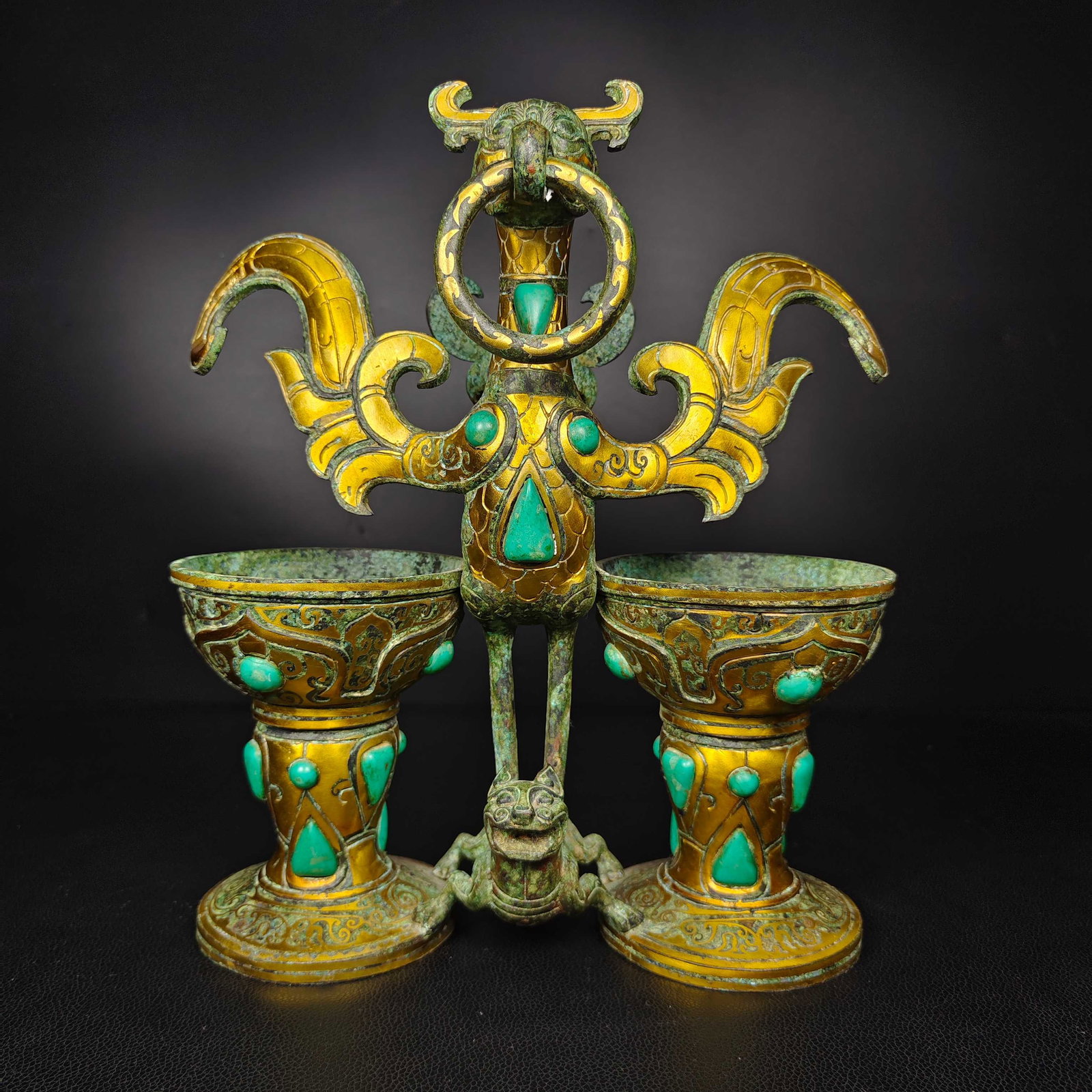 An Exquisite Bronze Inlaid Turquoise Phoenix -Shaped Candlestick: An Exquisite Bronze Inlaid Turquoise Phoenix -Shaped Candlestick Han Dynasty, China Size:11.8inx10.6in Weight:3.5kg青铜朱雀衔环杯