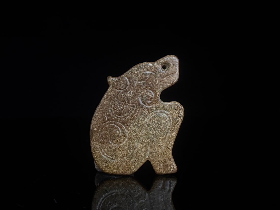 An Exquisite White Jade Auspicious Beast Pendant: An Exquisite White Jade Auspicious Beast Pendant Han Dynasty, China Size:2.6inx2inx0.2in Weight:35g白玉瑞兽佩 中国汉代 Size:6.5cmx5.0cmx0.5cm Weig