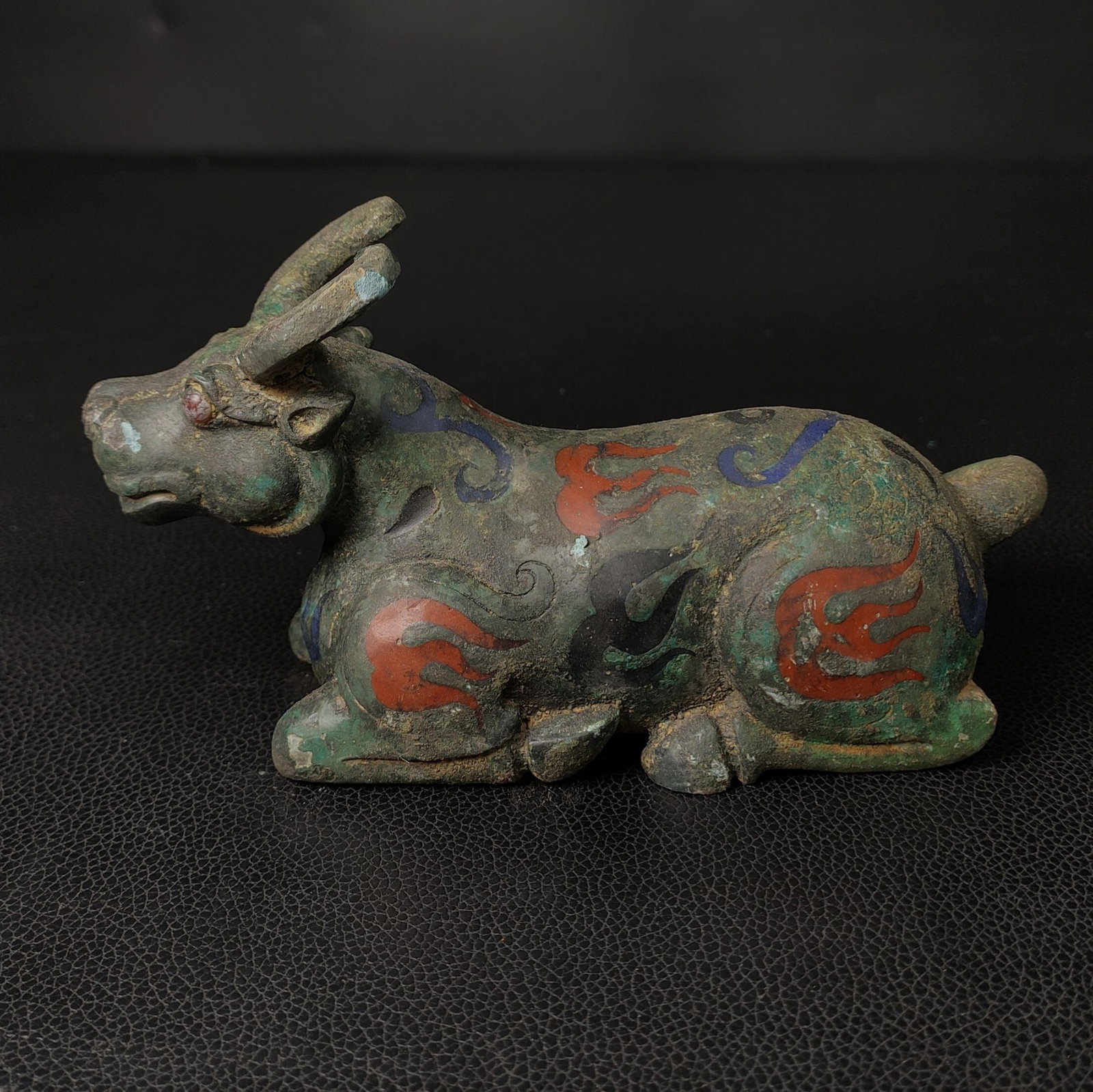 An Exquisite Bronze Buffalo Ornament: An Exquisite Bronze Buffalo Ornament the Warring States period in China Size:3.5inx6.3in Weight:0.5kg青铜卧牛摆件 战国时期 Size:9cmx16cm