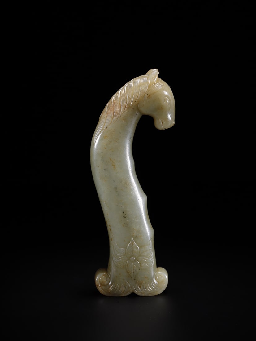 An Exquisite White Jade Horse head Ornament: An Exquisite White Jade Horse head Ornament Qing Dynasty, China Size:5.4inx1.8inx0.8in Weight:176.2g白玉马首刀柄 中国清代 Size:13.8cmx4.5cmx