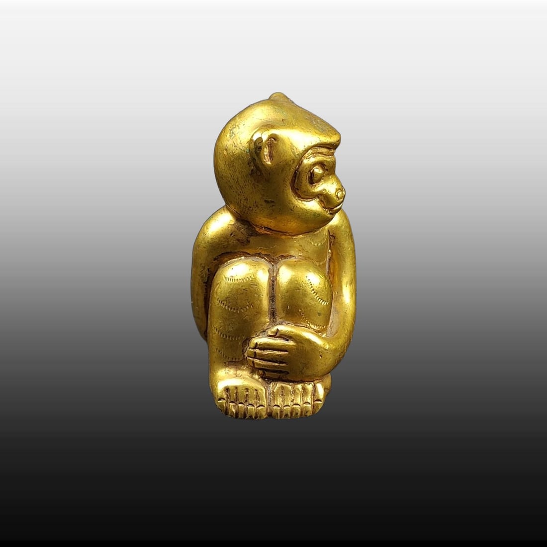 A Exquisite Gilt Bronze Monkey-shaped Ornament: A Exquisite Gilt Bronze Monkey-shaped Ornament,Han Dynasty, China,Size:2inx1.6in,Weight:203g 铜鎏金猴形摆件,中国汉代