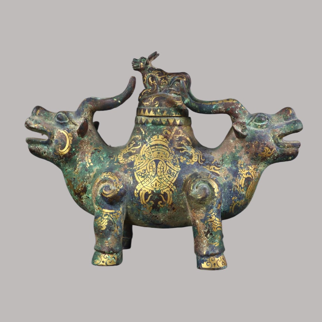 A Exquisite Gold and Silver-Inlaid Bronze Auspicious Beast Ornament: A Exquisite Gold and Silver-Inlaid Bronze Auspicious Beast Ornament,Han Dynasty, China,Size:9.8inx12.6inx4.7in,Weight:2980g