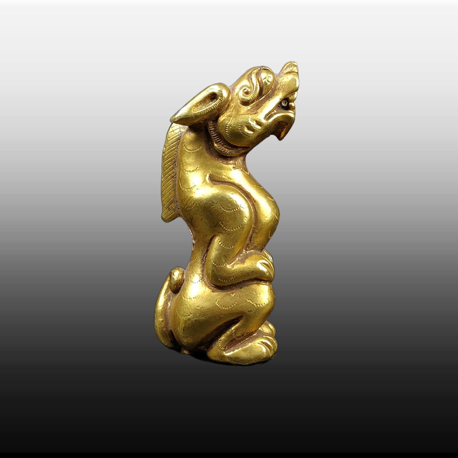 A Exquisite Gilt Bronze Auspicious Beast Ornament: A Exquisite Gilt Bronze Auspicious Beast Ornament,Han Dynasty, China,Size:2.8inx1.2in,Weight:189g 铜鎏金瑞兽摆件,中国汉代