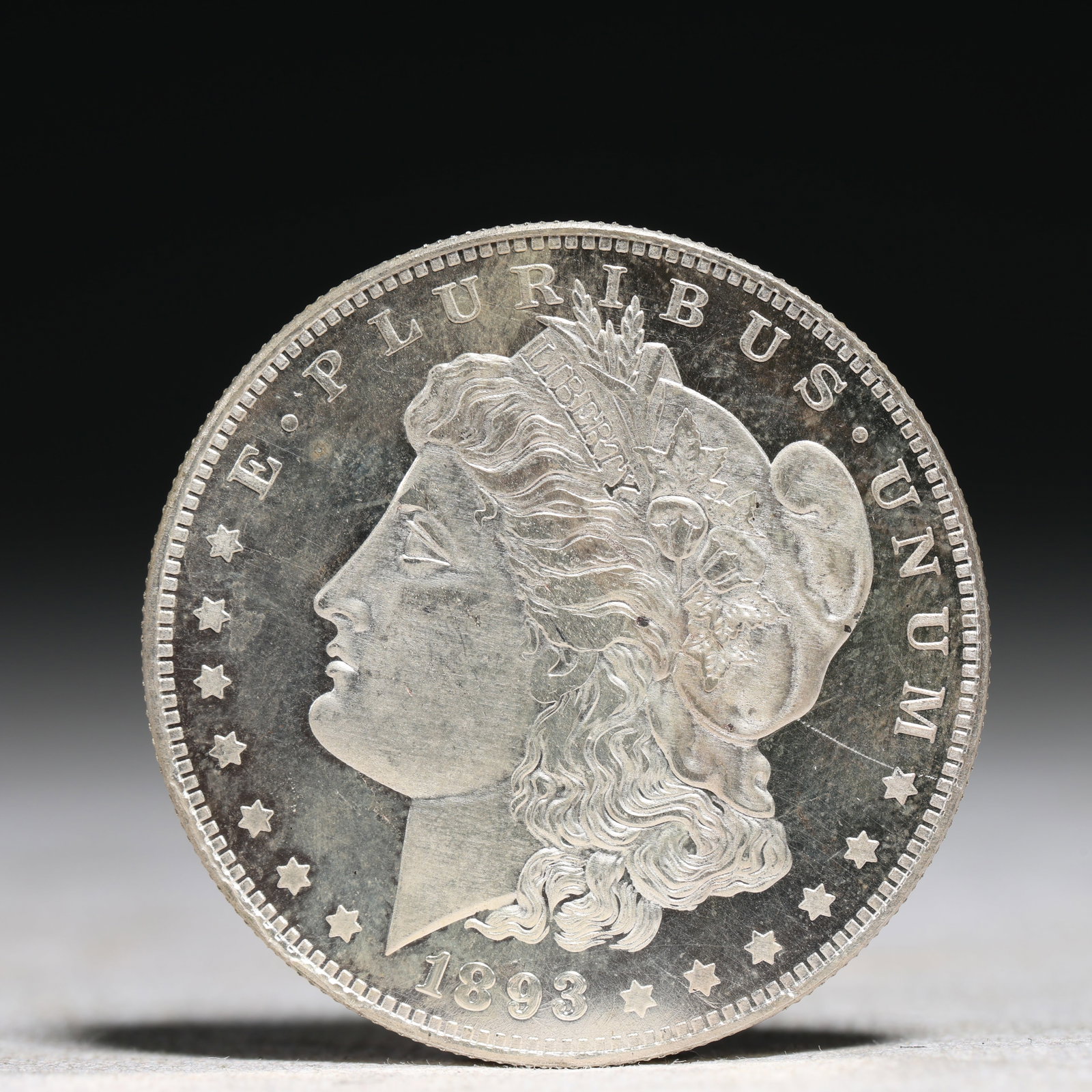 USA Morgan Dollar 1893 Coin: Obv: profile bust with date below and E PLURIBUS UNUM legend and stars around. Rev: eagle with In God we trust above within wreath with UNITED STATES OF AMERICA ONE DOLLAR legend. IN GOD WE TRUST /