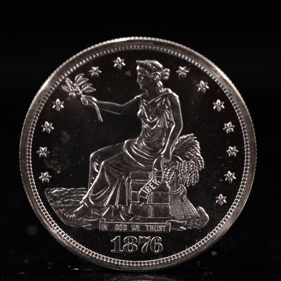 USA Trade Dollar 1876 Coin: American coin. Obverse: Liberty seated on a pedestal facing the sea to the left holding olive branches surrounded by 13 stars. IN GOD WE TRUST / LIBERTY / 1876. Reverse: An eagle holding branches with