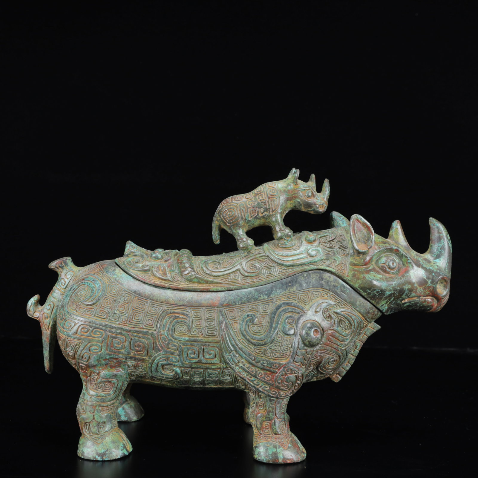 An Archaic Bronze Rhinoceros Cup,with Inscription: An Archaic Bronze Rhinoceros Cup,with Inscription,the Warring States Period in China,Size:13inx4.3inx8.7in,Weight:2850g