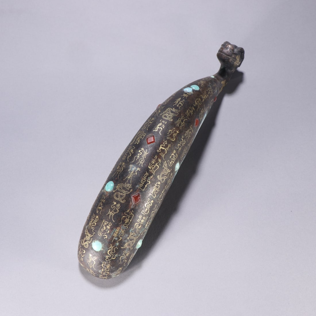 An Exquisite Bronze Inlaid Gold and Silver Inlaid Turquoise Hook: An Exquisite Bronze Inlaid Gold and Silver Inlaid Turquoise Hook Han Dynasty, China Size:10.2inx1.8in铜错金银镶松石带钩