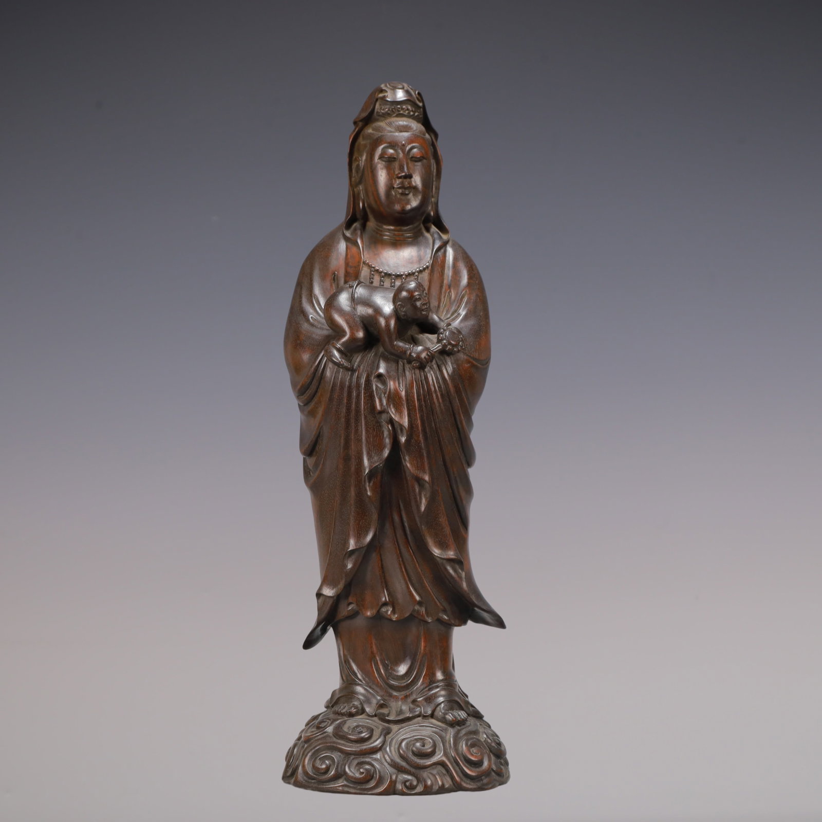 A Exquisite Zitanwood Statue of Avalokitesvara Ornament: A Exquisite Zitanwood Statue of Avalokitesvara Ornament Qing Dynasty, China Size:4.6inx4.1inx14.6in Weight:1650g紫檀木观音摆件