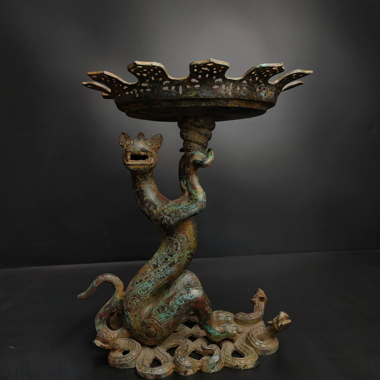 An Exquisite Bronze Auspicious Beast -Shaped With Inscription Candlestick: An Exquisite Bronze Auspicious Beast -Shaped With Inscription Candlestick Han Dynasty, China Size:11.8inx8.3in Weight:3.3kg青铜神兽灯 中国汉代