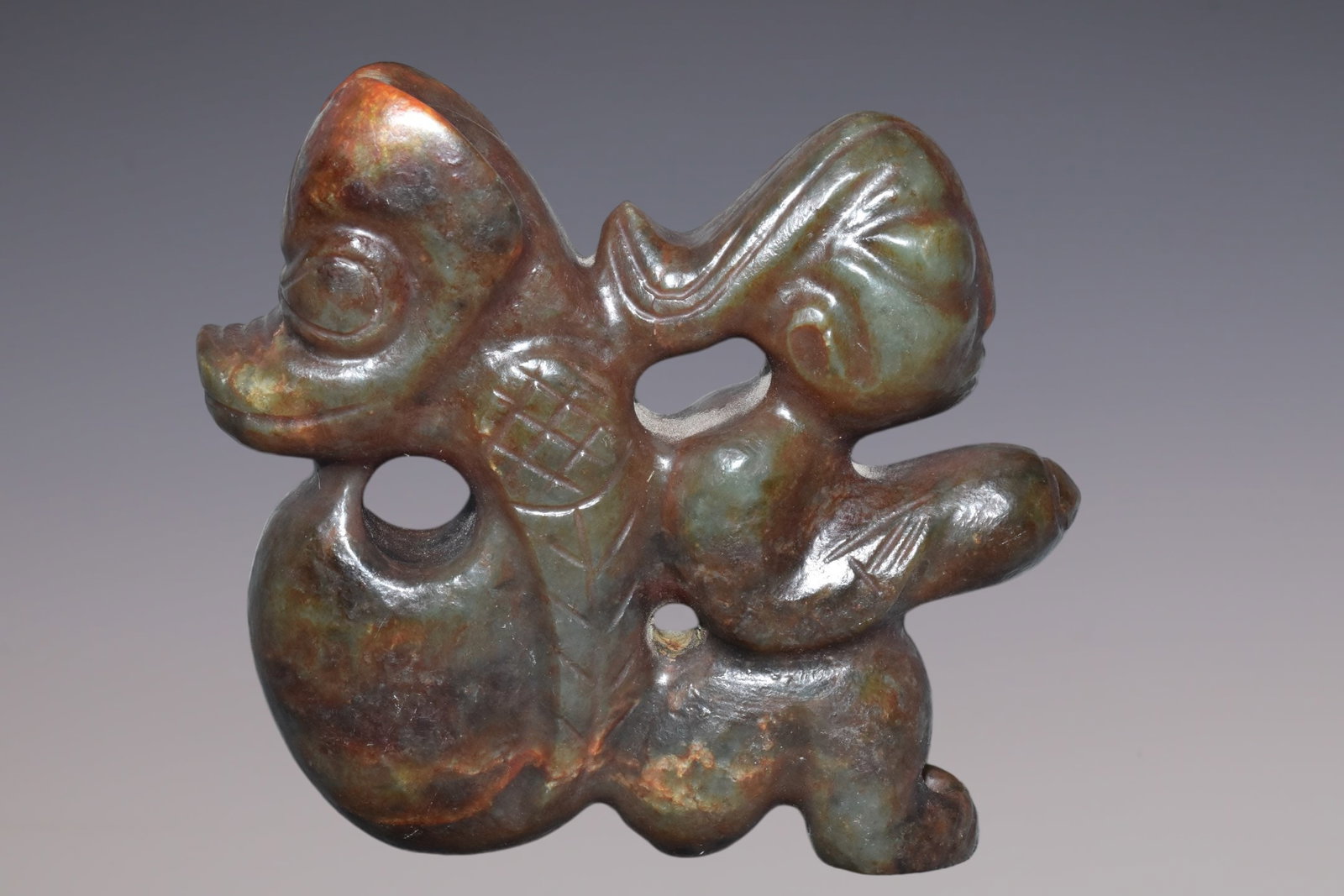 An Exquisite Hemo Jade Figure: An Exquisite Hemo Jade Figure Hong Shan Culture Size:5.3inx5.3in Weight:880g河磨玉人 红山文化 Size:13.5cmx13.5cm Weight:880g