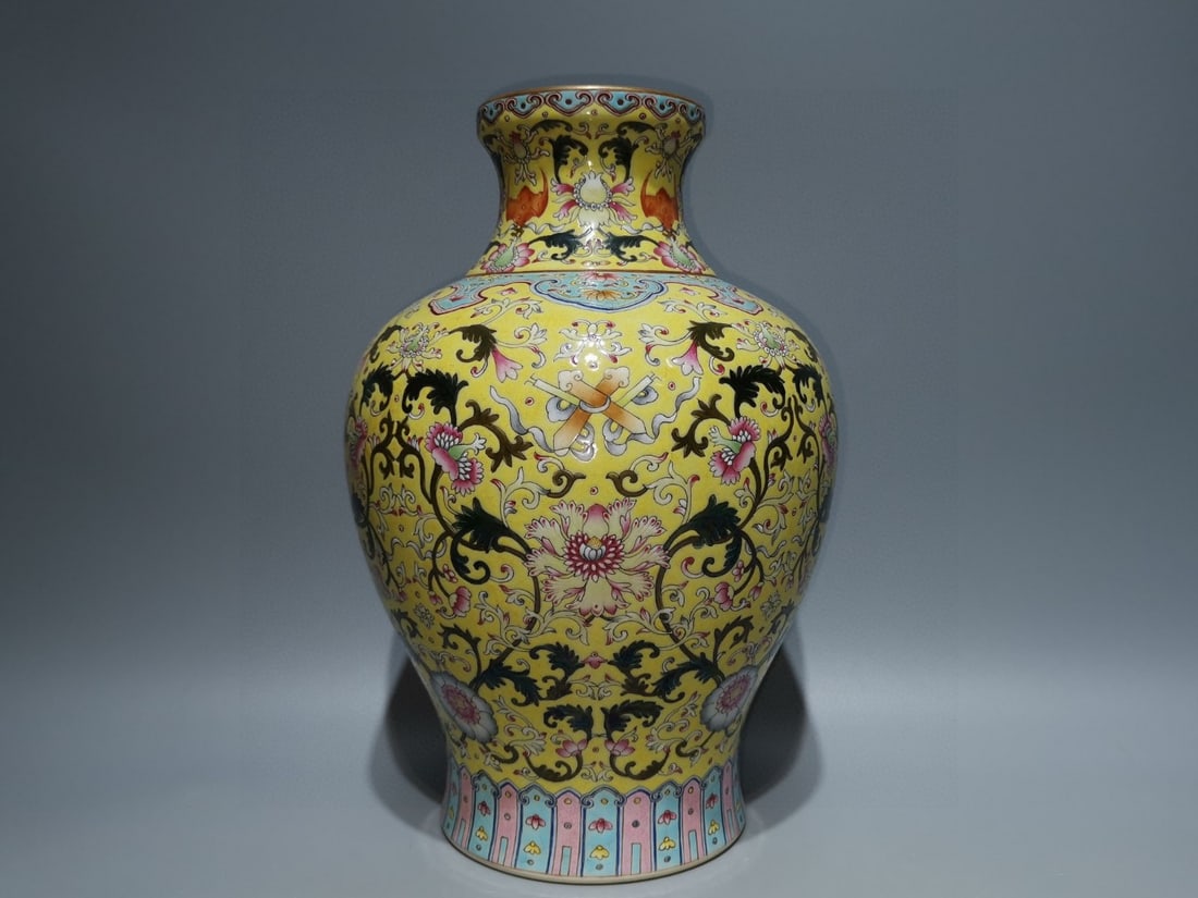An Exquisite Enamel Lotus Pattern Vase: An Exquisite Enamel Lotus Pattern Vase Qing Dynasty, China Qianlong Six-character Mark Size:9.6inx6.9in黄地珐琅彩福运连橄榄瓶
