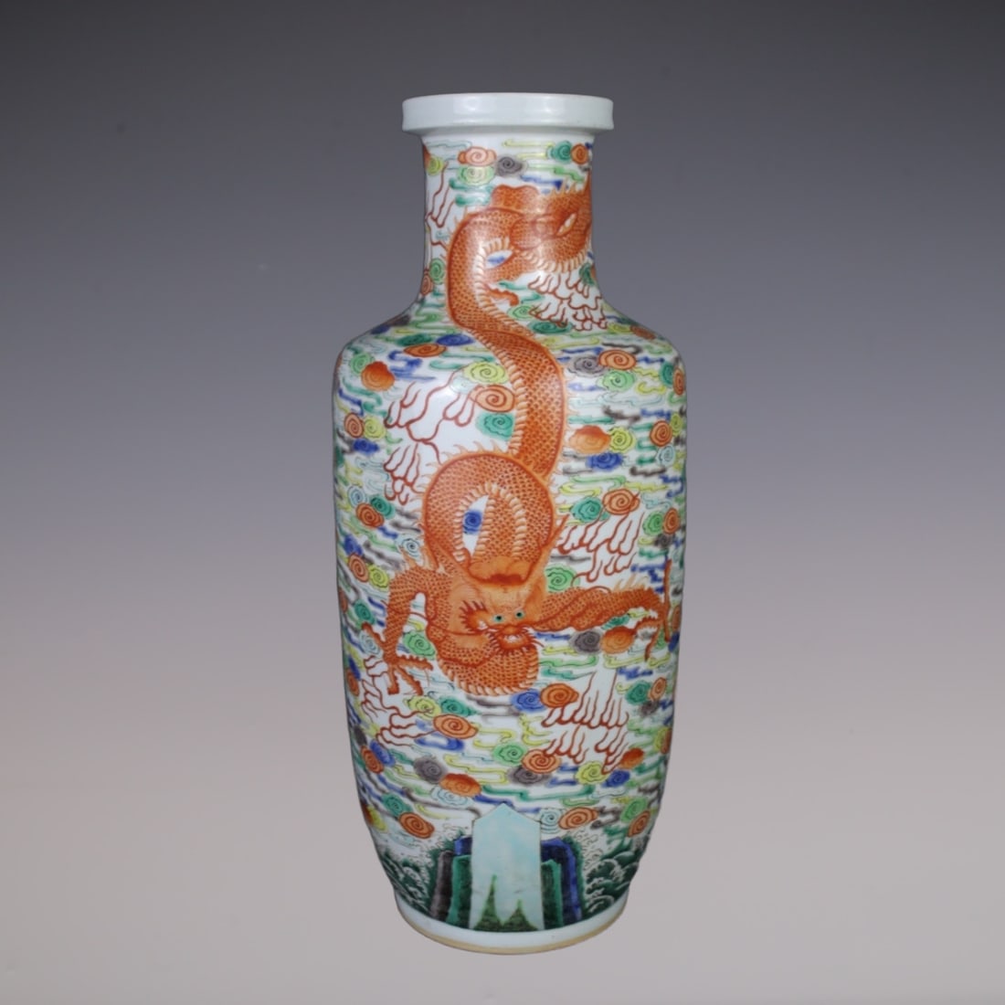 An Exquisite Wucai Dragon Pattern Seawater Pattern Vase: An Exquisite Wucai Dragon Pattern Seawater Pattern Vase Qing Dynasty, China Kangxi Six-character Mark Size:18.7inx5.7in五彩云龙图案棒槌瓶 中