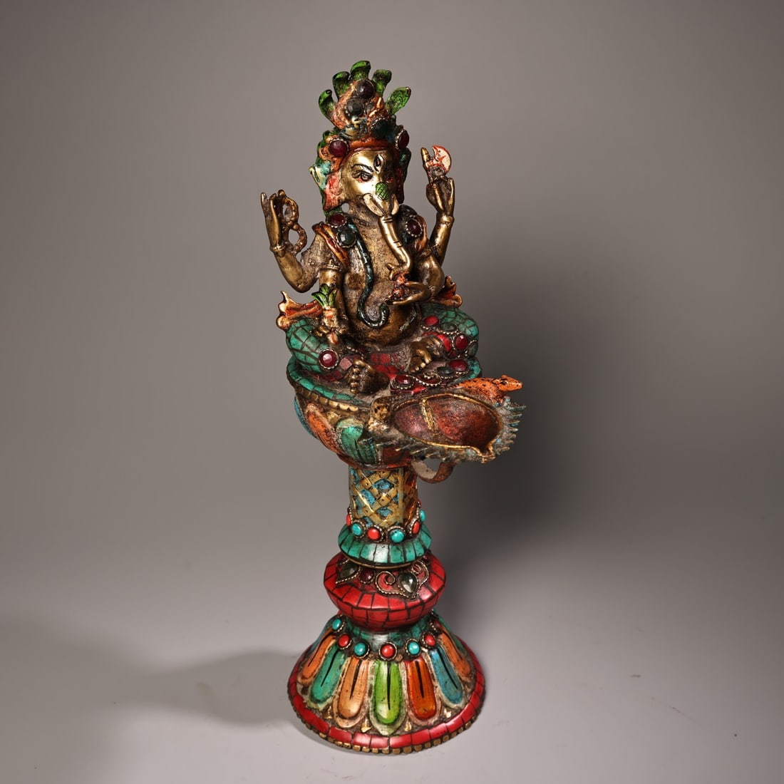 An Exquisite Bronze Painted Gold Painted Color Inlaid Gems Statue of Ganesh: An Exquisite Bronze Painted Gold Painted Color Inlaid Gems Statue of Ganesh Qing Dynasty, China Size:11.8inx3.9in Weight:1600g铜彩绘描金象鼻财神 &