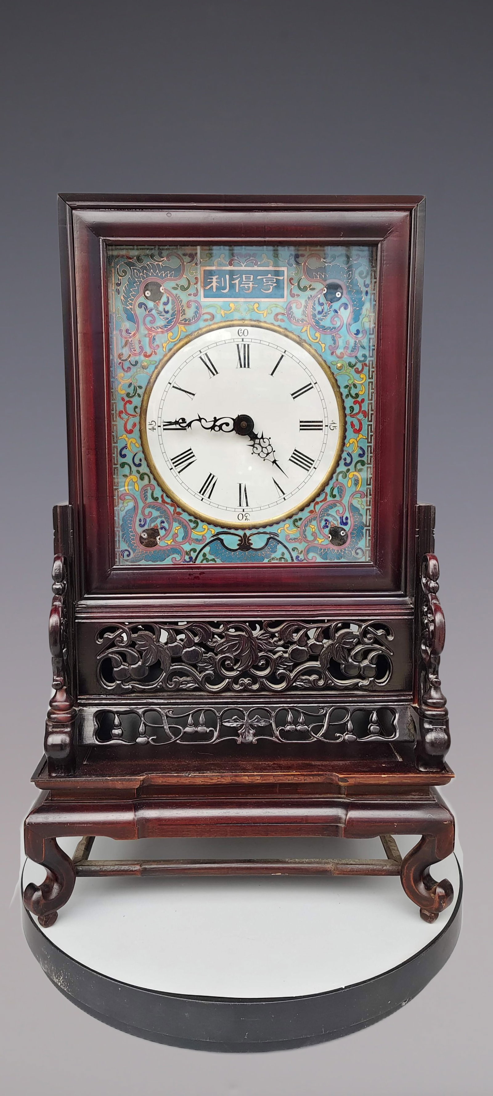 An Exquisite Cloisonne Inlaid Redwood Lotus Pattern Clock: An Exquisite Cloisonne Inlaid Redwood Lotus Pattern Clock Size:25.2inx14.5in景泰蓝嵌红木缠枝莲纹钟表 Size:64.1cmx36.8cm