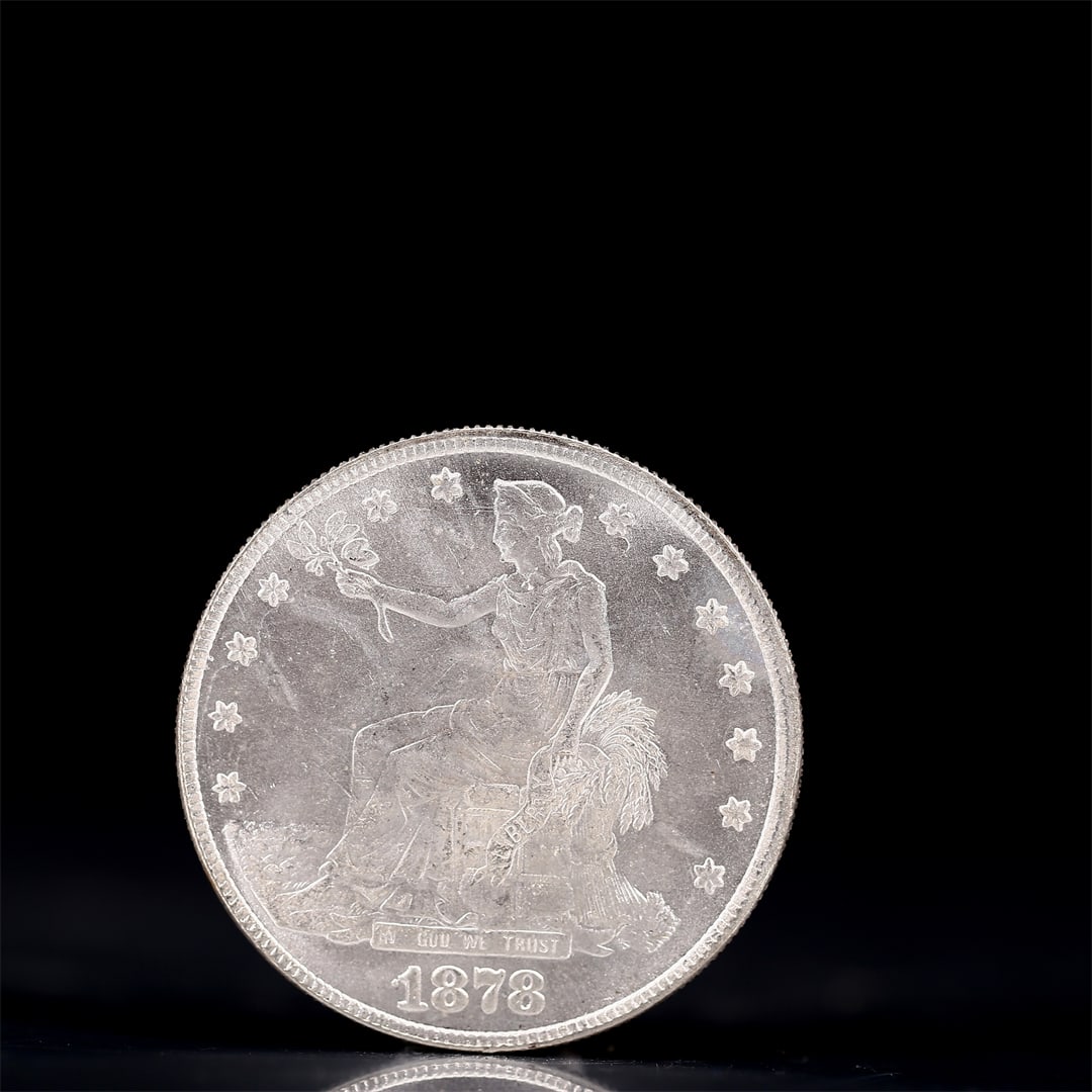 USA Trade Dollar 1878 Coin: American coin. Obverse: Liberty seated on a pedestal facing the sea to the left holding olive branches surrounded by 13 stars. IN GOD WE TRUST / LIBERTY / 1878. Reverse: An eagle holding branches
