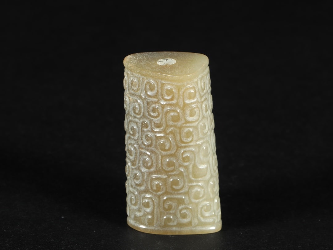 An Exquisite White Jade Ornament: An Exquisite White Jade Ornament Han Dynasty, China Size:1.7inx1inx0.9in Weight:46g白玉卷云纹勒子 中国汉代 Size:4.4cmx2.6cmx2.2cm