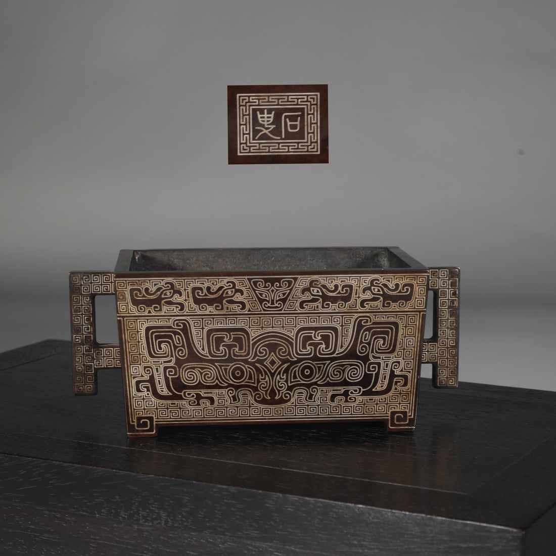 An Exquisite Bronze Inlaid Silver Beast-Face Pattern Double-Ears Censer: An Exquisite Bronze Inlaid Silver Beast-Face Pattern Double-Ears Censer Ming Dynasty, China Size:3.1inx7.9in Weight:3kg铜错银丝饕餮纹马槽炉