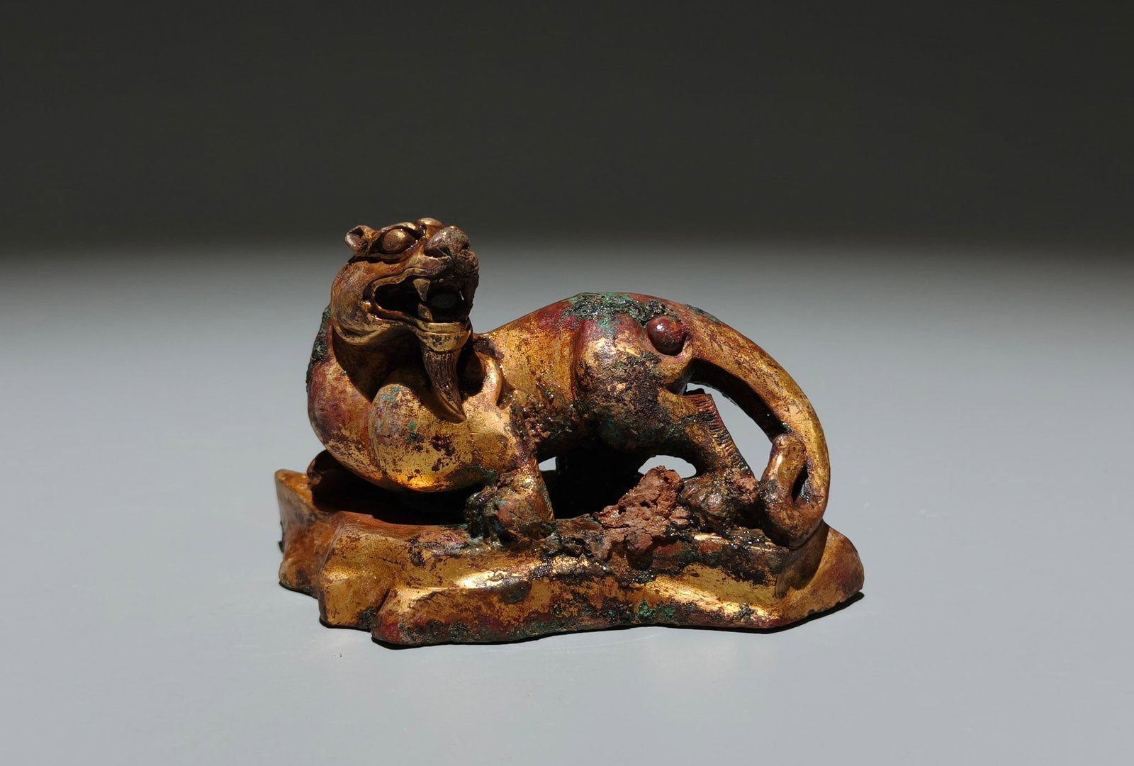 A Exquisite Gilt Bronze Tiger-shaped Auspicious Beast: A Exquisite Gilt Bronze Tiger-shaped Auspicious Beast,Han Dynasty, China,Size:2.2inx3.5inx1.6in 铜鎏金虎形兽,中国汉代