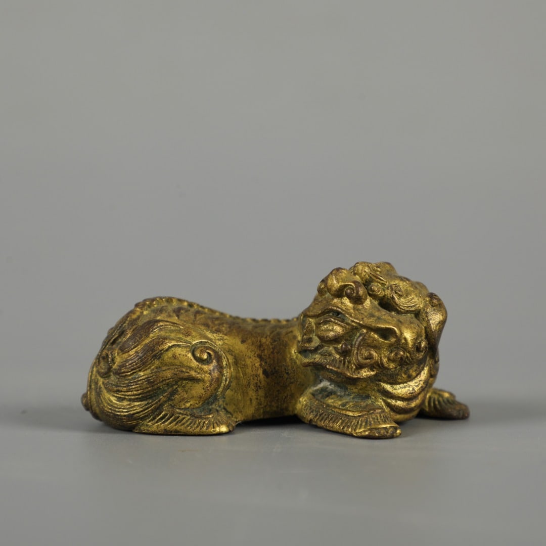A Exquisite Gilt Bronze Lion Ornament: A Exquisite Gilt Bronze Lion Ornament,Qing Dynasty, China,Size:1.2inx2.6in 铜鎏金狮摆件,中国清代