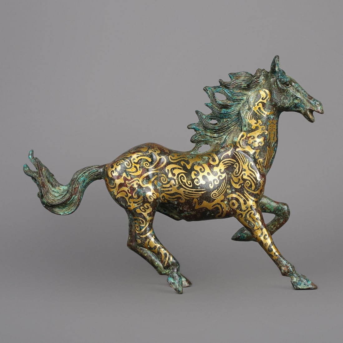 A Exquisite Gold-inlaid Bronze Horse Ornament: A Exquisite Gold-inlaid Bronze Horse Ornament,Han Dynasty, China,Size:8.7inx2inx6.7in,Weight:1050g 青铜错金马摆件,中国汉代