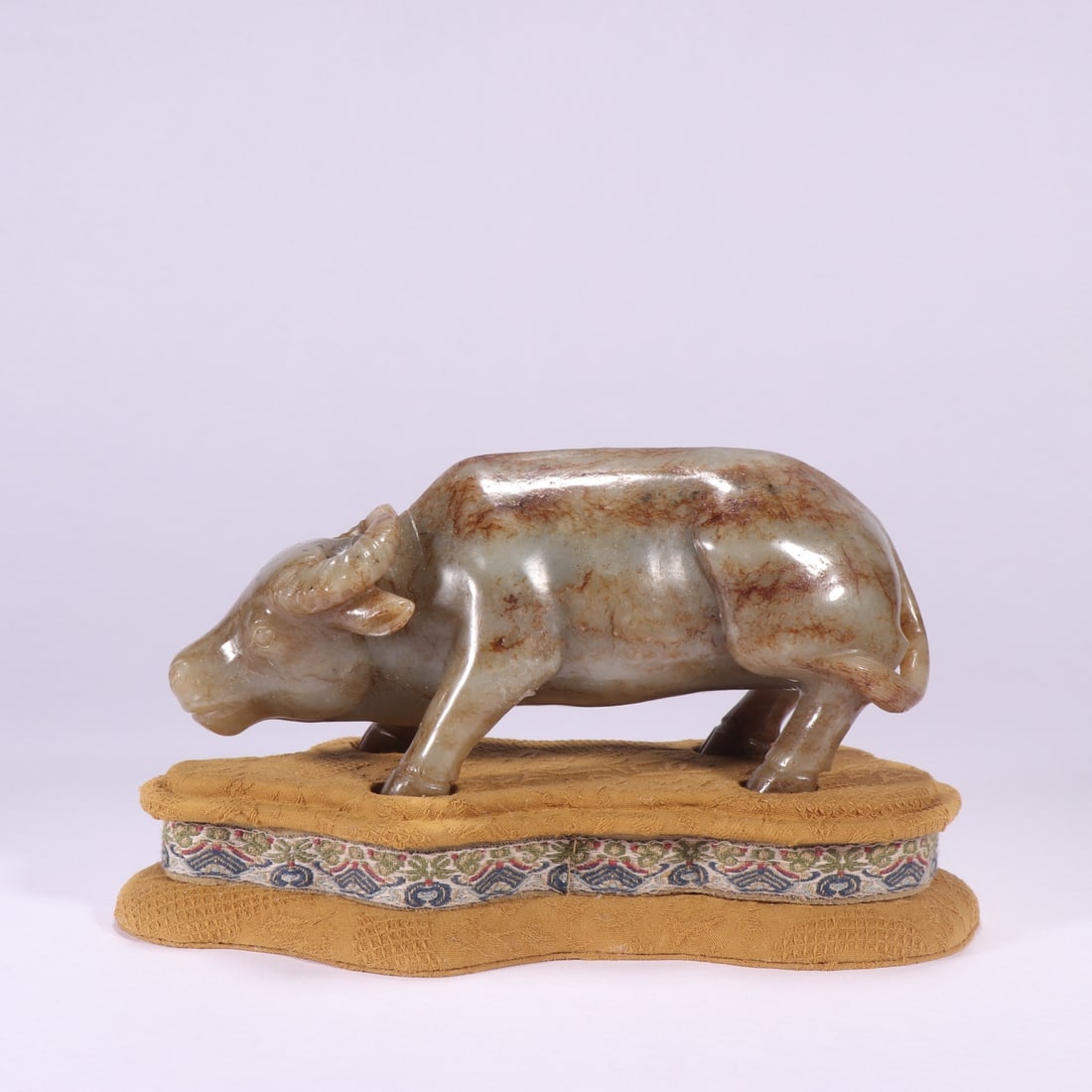 A Exquisite Hotan Jade Buffalo Ornament: A Exquisite Hotan Jade Buffalo Ornament,Qing Dynasty, China,Size:7.1inx3.1in,Weight:1056.7g 和田玉牛摆件,中国清代