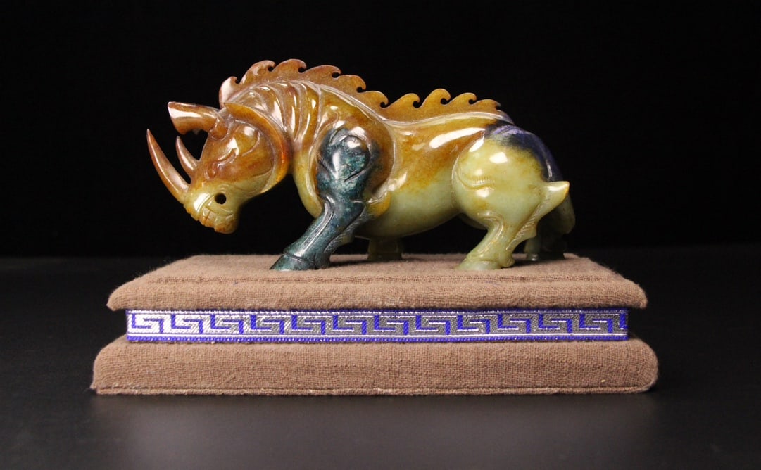 A Exquisite Hotan Jade Painted Color Rhinoceros Ornament: A Exquisite Hotan Jade Painted Color Rhinoceros Ornament,Qing Dynasty, China,Size:6.3inx2.2inx3.1in ,Weight:487g 和田玉彩绘犀牛摆件,中ࢲ