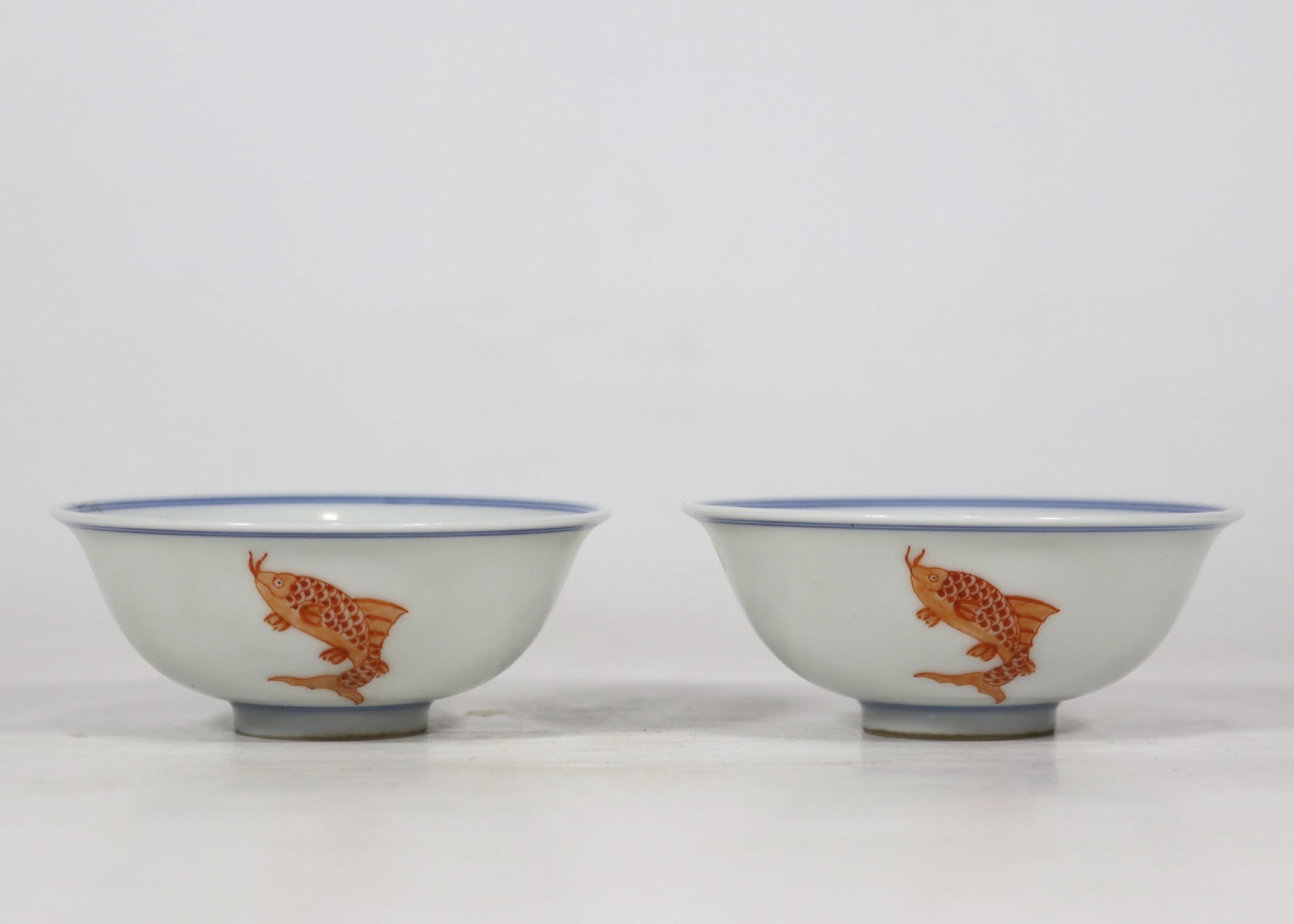 A pair of Exquisite Blue and White Iron-Red Fish Pattern Cup: A pair of Exquisite Blue and White Iron-Red Fish Pattern Cup,Qing Dynasty, China,Yongzheng Six-character Mark,Size:3.3inx1.4in 一对青花矾红鱼纹杯,