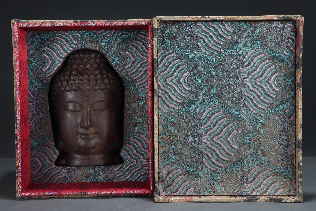 An Exquisite Eaglewood Buddha head: An Exquisite Eaglewood Buddha head Qing Dynasty, China Size:5.5inx5.5inx8.1in沉香佛头 中国清代 Size:14cmx14cmx20.5cm