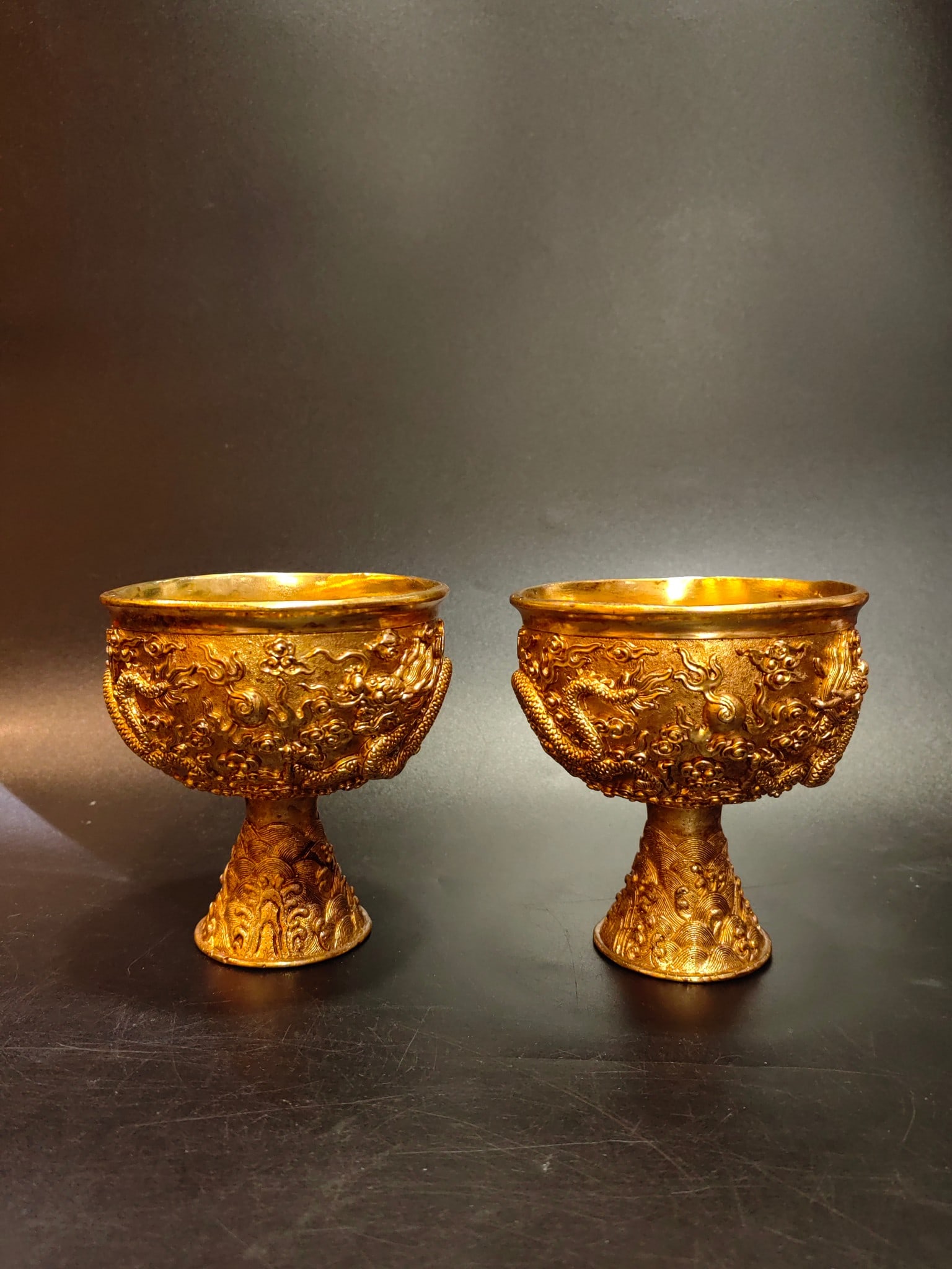 An Exquisite Gilt Bronze Dragon Pattern Cup: An Exquisite Gilt Bronze Dragon Pattern Cup Qing Dynasty, China Size:4.1inx4.1inx4.5in Weight:624g铜鎏金双龙高足杯 中国清代 Size