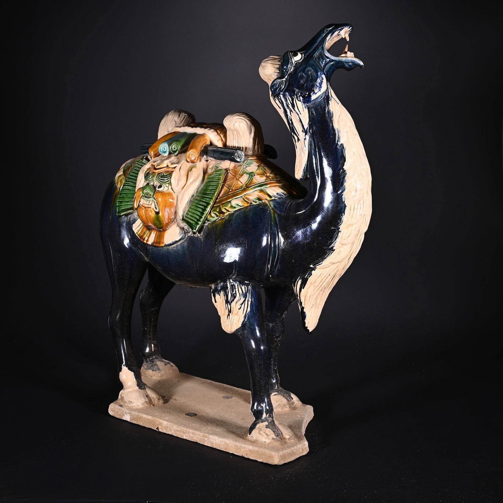 A Huge Tang Tri-Color Glazed Pottery Beast-Face Pattern Camel Ornament: A Huge Tang Tri-Color Glazed Pottery Beast-Face Pattern Camel Ornament,Tang Dynasty, China,Size:19.9inx15.9inx9.1in,Weight:8750g唐三彩兽面纹骆驼摆