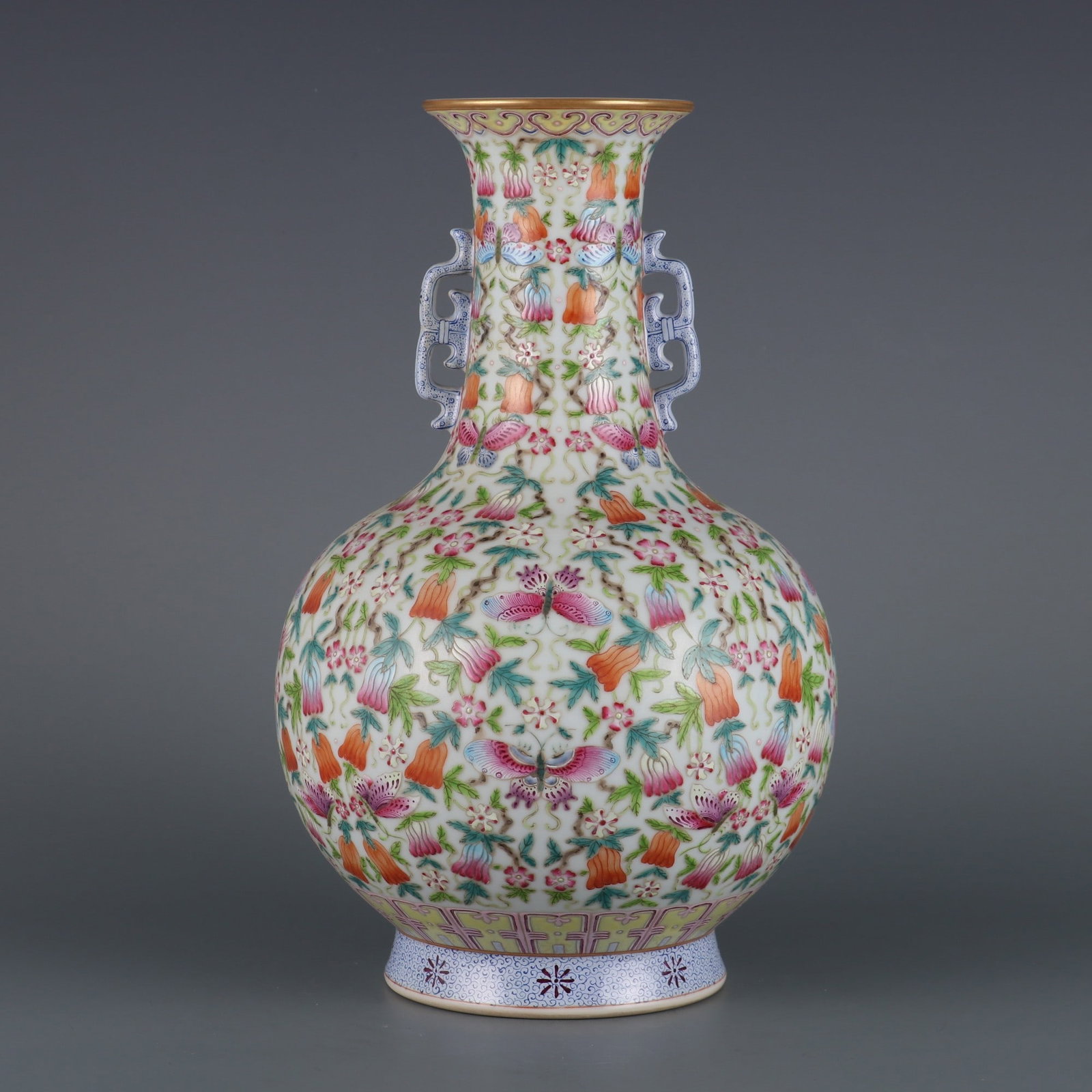 An Exquisite Famille-Rose Flower and Butterfly Pattern Double-Ears Vase: An Exquisite Famille-Rose Flower and Butterfly Pattern Double-Ears Vase Qing Dynasty, China Qianlong Six-character Mark Size:11.9inx3.5in粉彩瓜蝶绵绵双耳