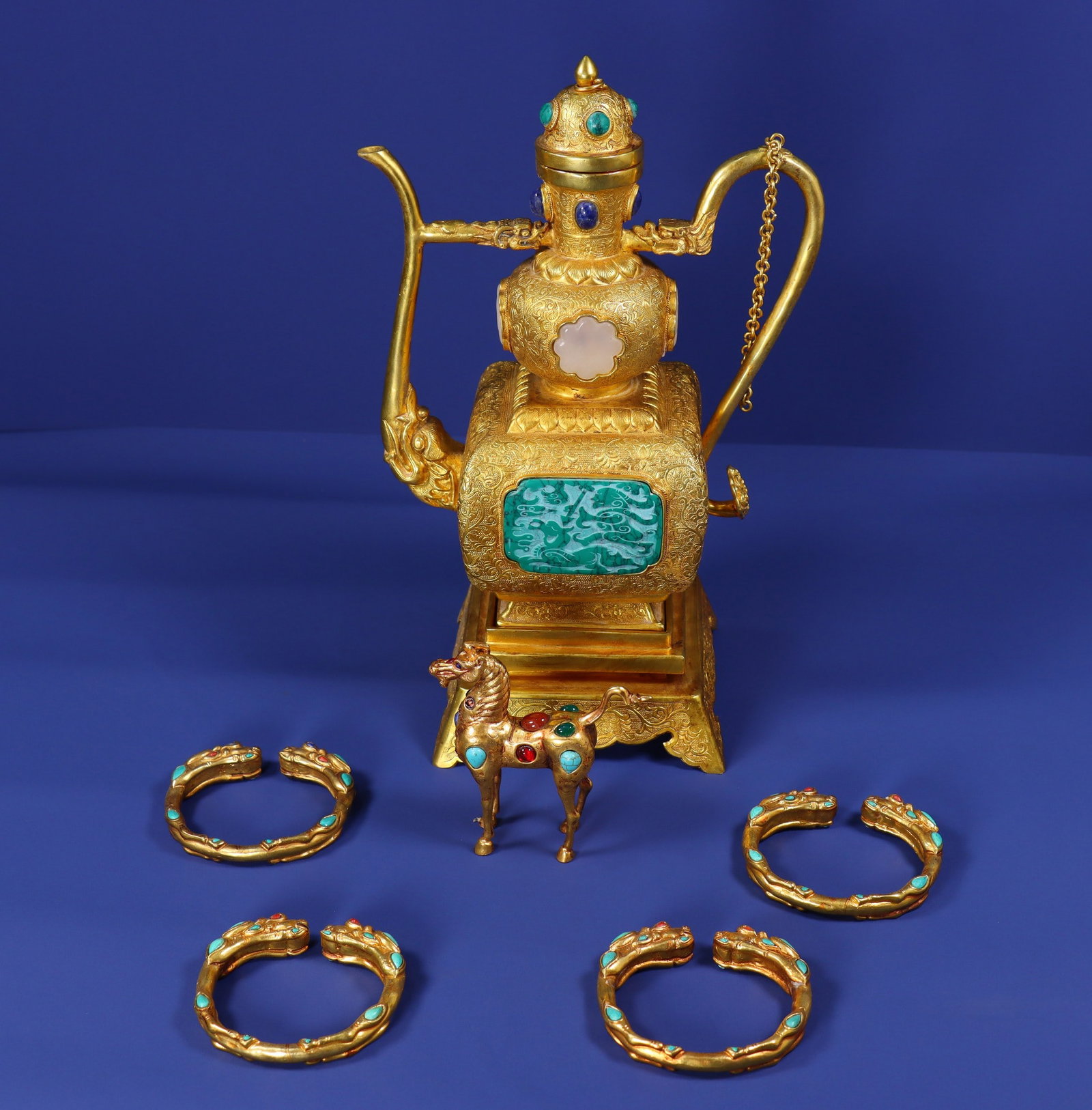 A Set of Exquisite Purple Copper Gilt Inlaid Gems Ewer: A Set of Exquisite Purple Copper Gilt Inlaid Gems Ewer,Qing Dynasty, China,Size:11.8inx7.5inx5.1in(Pot),3.9inx3.5inx1.2in(Horse),3.1inx2.8in(Bracelet),Weight:2250g 一套紫铜%