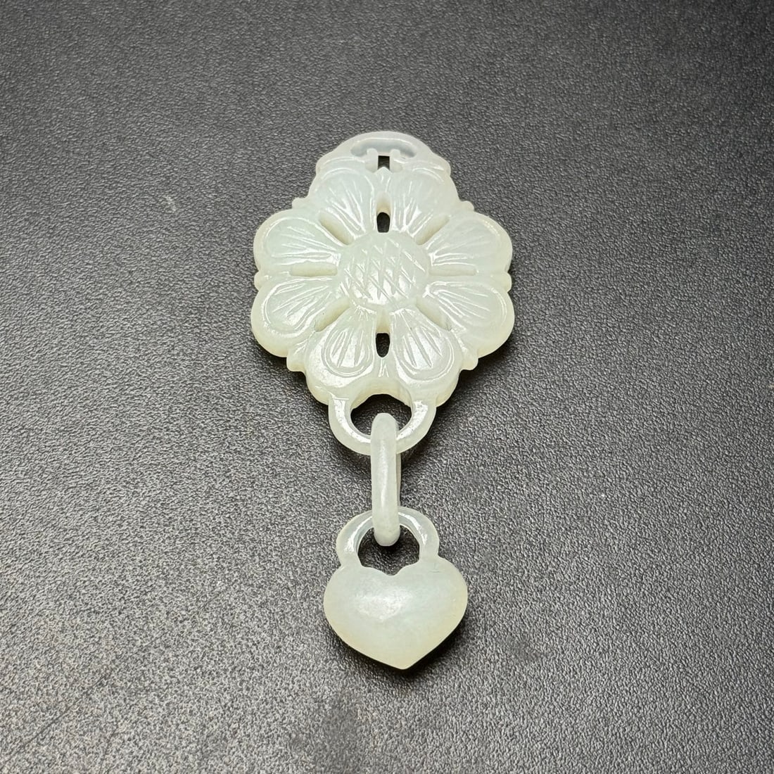 A Exquisite Hotan Jade Flower Shape Pendant: A Exquisite Hotan Jade Flower Shape Pendant,Qing Dynasty, China,Size:2.6inx1.2inx0.3in, Weight:16g 和田玉花卉形玉坠,中国清代