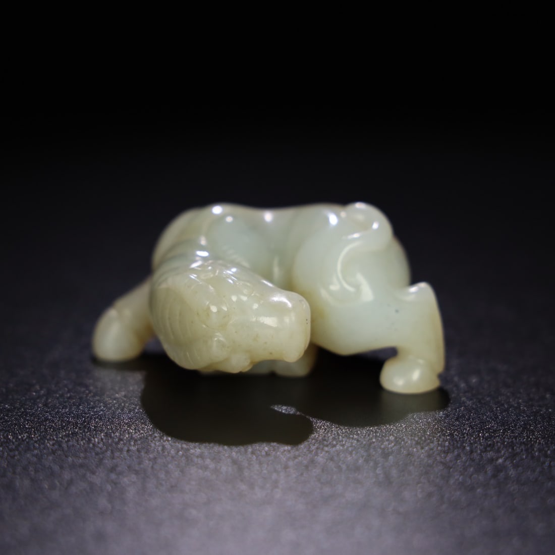 A Exquisite Hotan Jade Buffalo Ornament: A Exquisite Hotan Jade Buffalo Ornament,Ming Dynasty, China,Size:2.3inx2inx1.2in,Weight:98.3g 和田玉牛摆件,中国明代