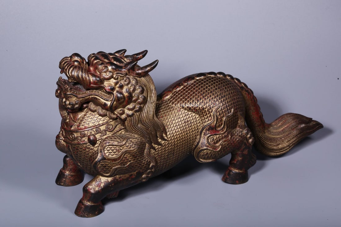 A Exquisite Coppery Lacquered Gilt Kylin Ornament: A Exquisite Coppery Lacquered Gilt Kylin Ornament,Ming Dynasty, China,Yongle Six-character Mark,Size:6.7inx13.4inx4.3in ,Weight:4166g 铜漆金麒麟摆件,中&