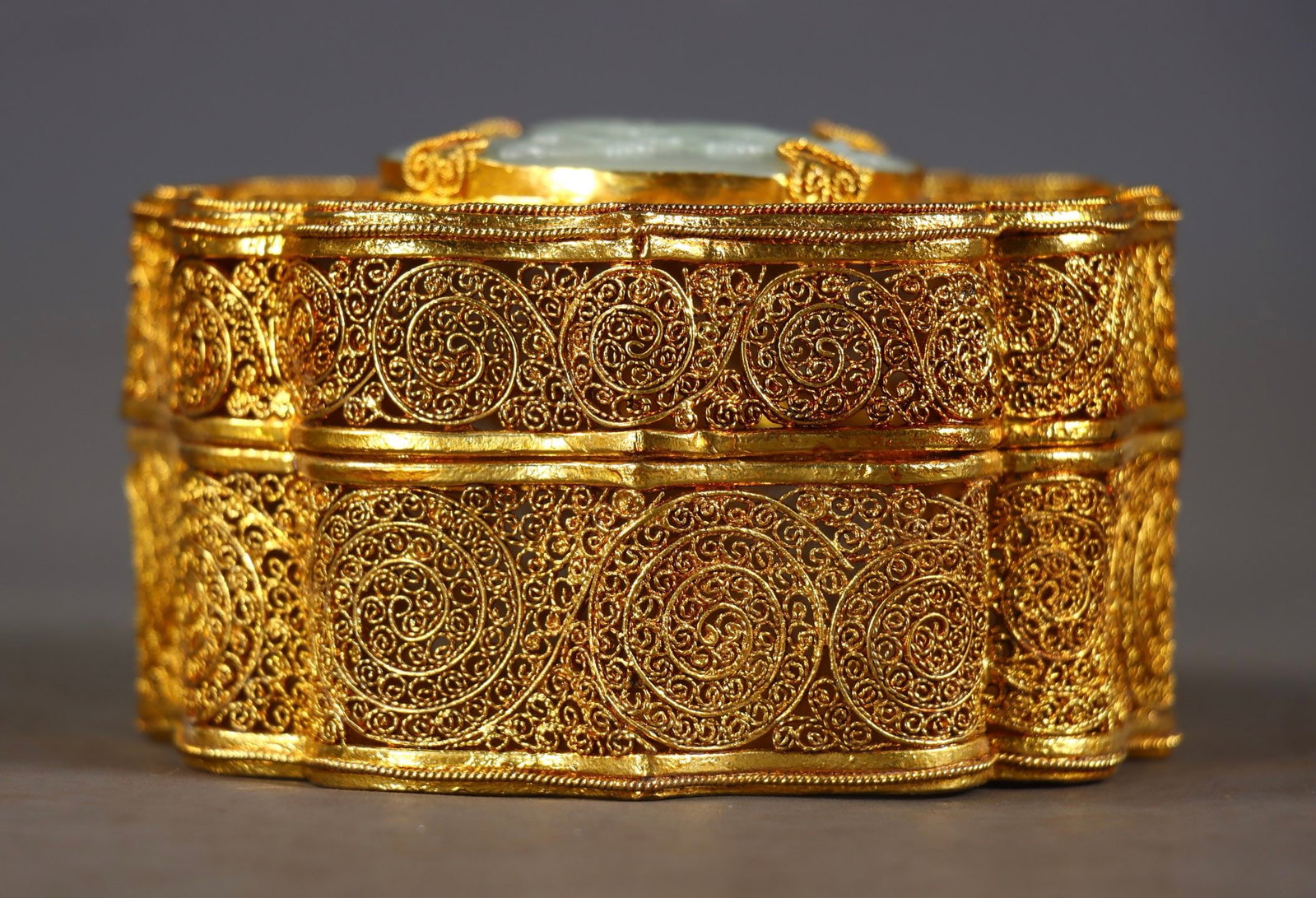 An Exquisite Gilt Bronze Inlaid White Jade Character and Story Pattern Box: An Exquisite Gilt Bronze Inlaid White Jade Character and Story Pattern Box Qing Dynasty, China Size:2.6inx4.1in