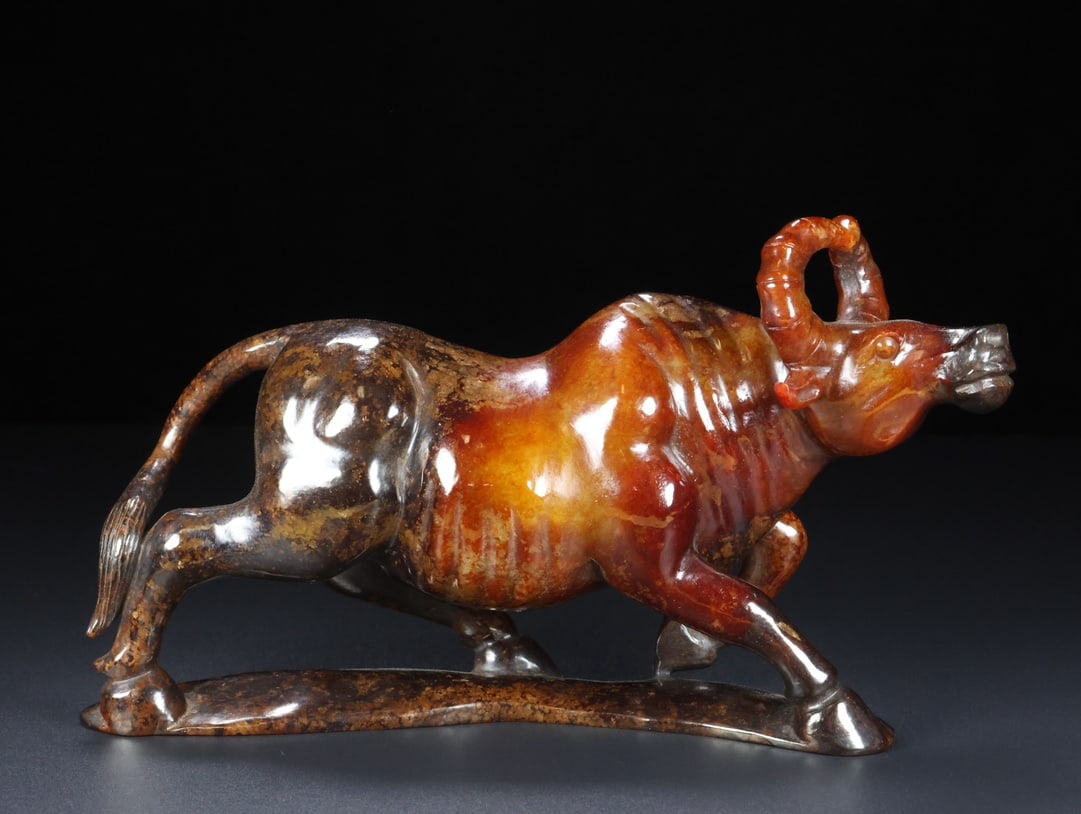 A Exquisite Hotan Jade Buffalo Ornament: A Exquisite Hotan Jade Buffalo Ornament,Han Dynasty, China,Size:9.4inx2.6inx5.1in ,Weight:1425g 和田玉牛摆件,中国汉代