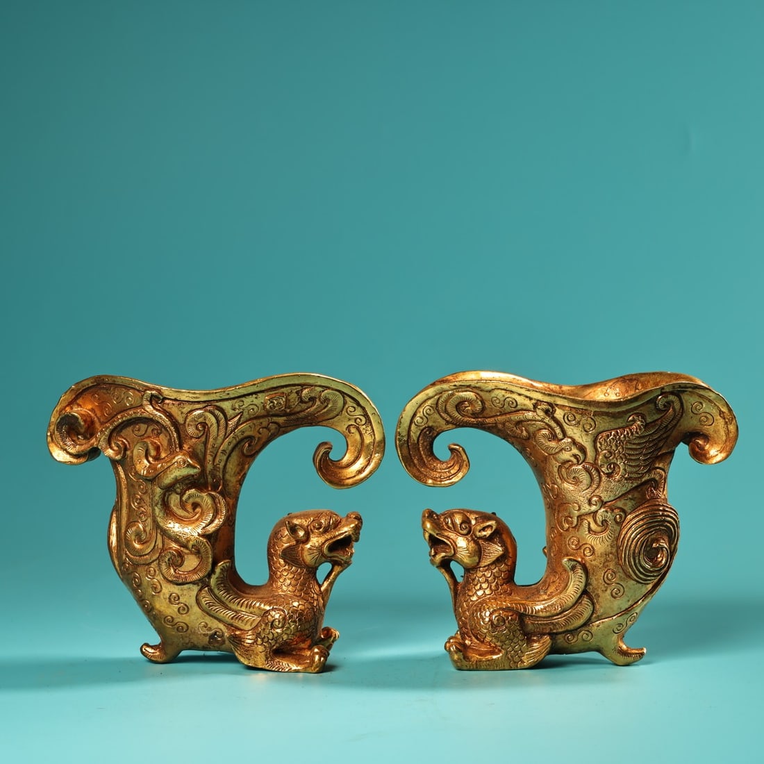 A pair of Exquisite Gilt Bronze Dragon and Phoenix Pattern Cup: A pair of Exquisite Gilt Bronze Dragon and Phoenix Pattern Cup,Tang Dynasty, China,Zhenguan Four-character Mark,Size:4.1inx4.7in,Weigh:950g 一对铜鎏金龙凤